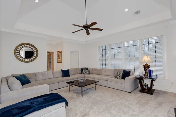 a living room with a couch and a chandelier