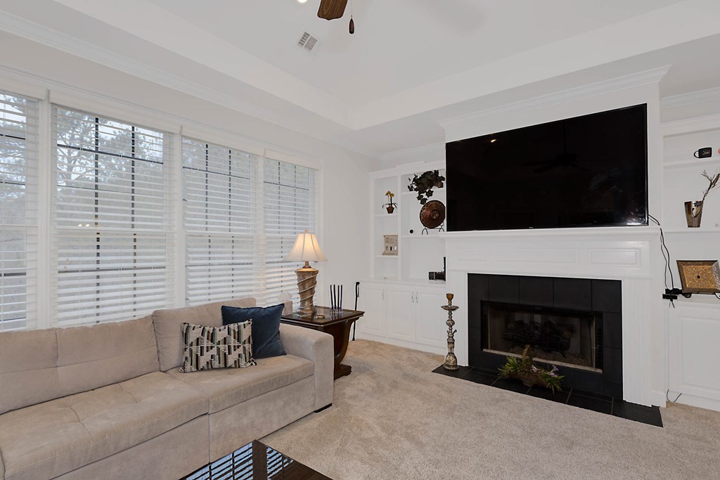7633 Grand Ridge Road Columbus, GA 31904 - Photo 38 of 61 a living room with furniture a fireplace and a flat screen tv