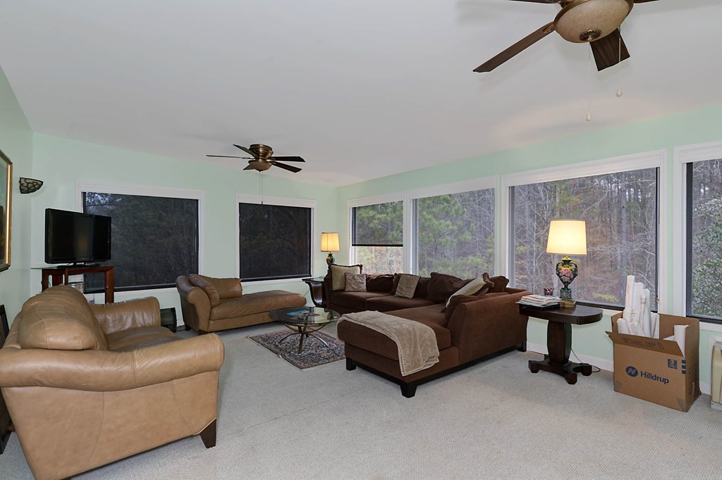7633 Grand Ridge Road Columbus, GA 31904 - Photo 39 of 61 a living room with furniture and a flat screen tv