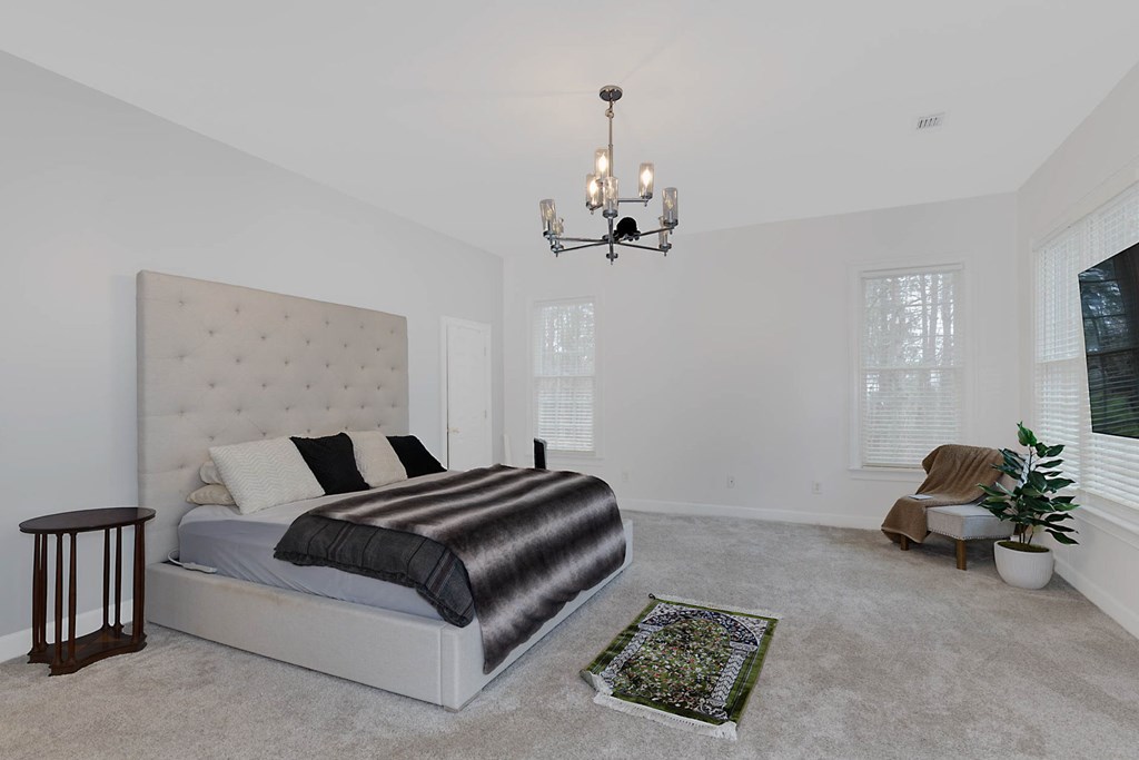7633 Grand Ridge Road Columbus, GA 31904 - Photo 44 of 61 a living room with a couch and a chandelier
