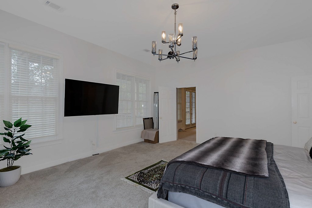 7633 Grand Ridge Road Columbus, GA 31904 - Photo 45 of 61 a bedroom with a large bed and a flat screen tv