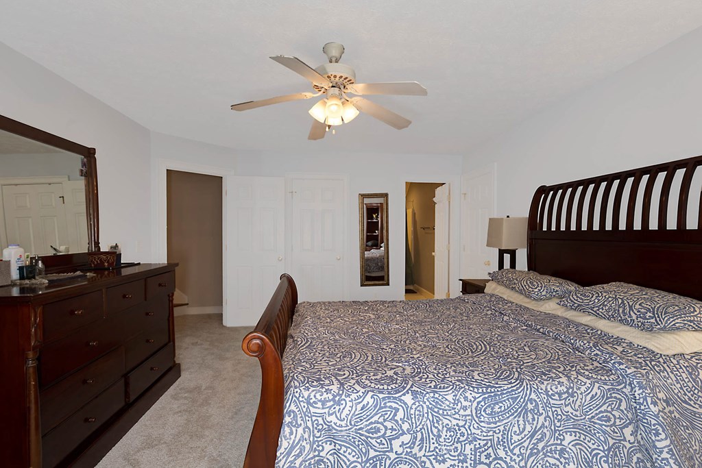 7633 Grand Ridge Road Columbus, GA 31904 - Photo 51 of 61 a bedroom with a bed and a chandelier