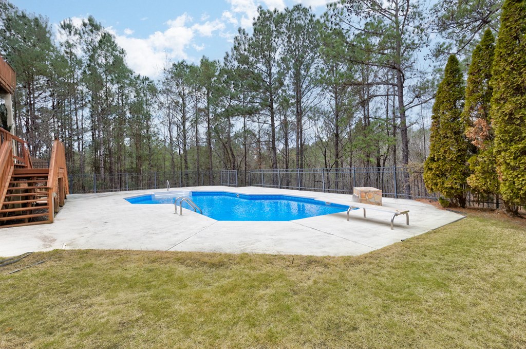 7633 Grand Ridge Road Columbus, GA 31904 - Photo 56 of 61 a view of a swimming pool with a patio