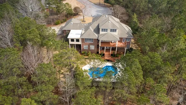 an aerial view of a house with a yard and potted plants
