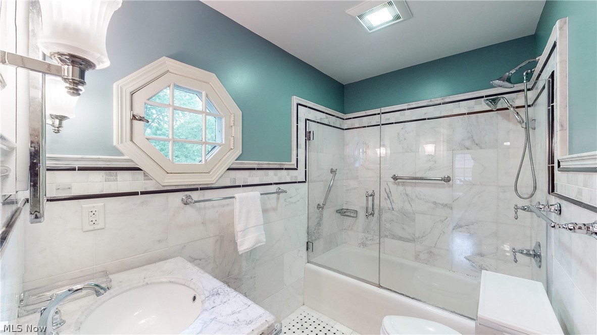 3658 Traver Road Shaker Heights, OH 44122 - Photo 15 of 33 Full bathroom with oversized vanity, combined bath / shower with glass door, toilet, and tile walls