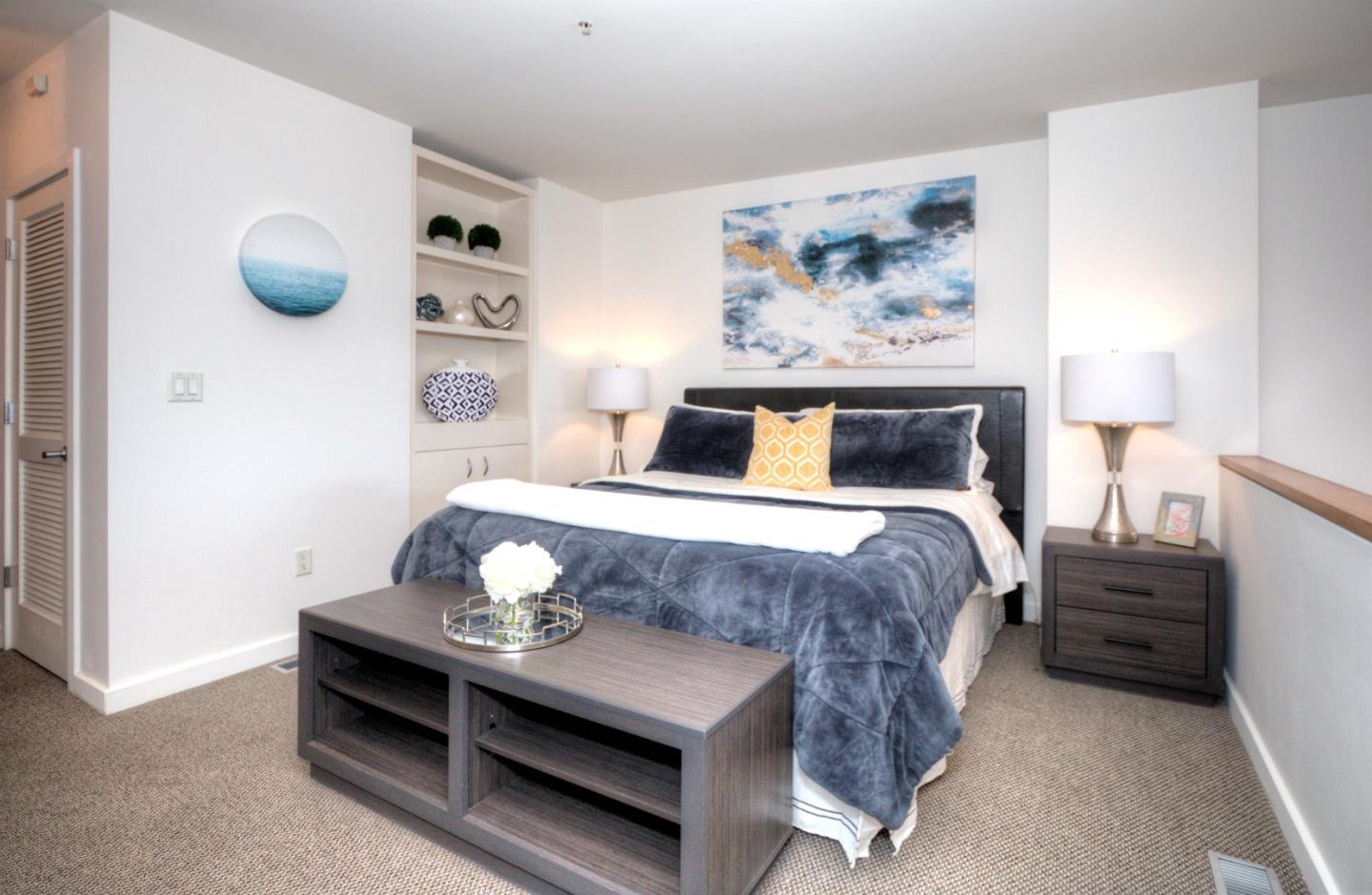 334 Santana Row, Unit 304 San Jose, CA 95128 - Photo 12 of 18 a bedroom with a bed and a wall painting