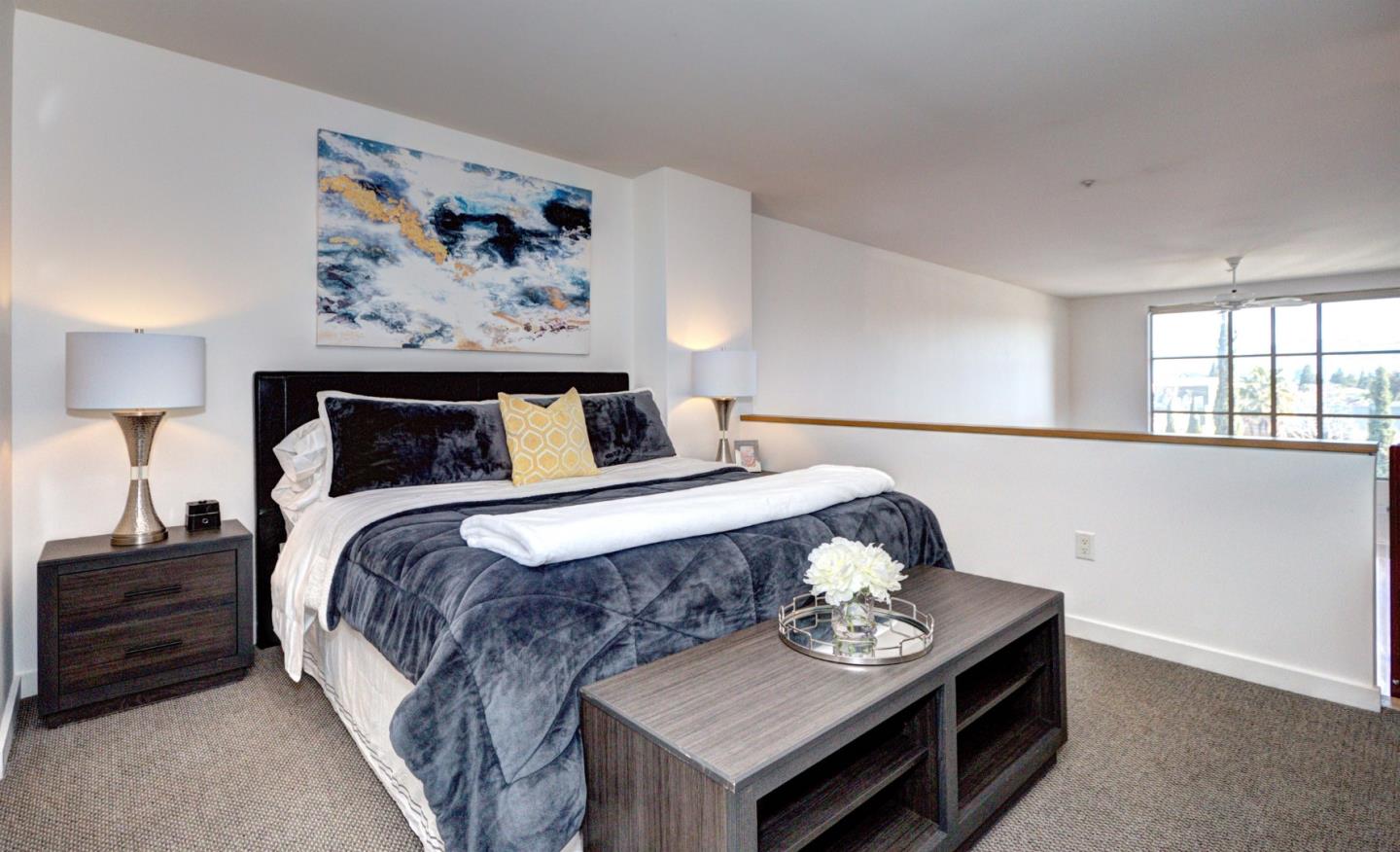 334 Santana Row, Unit 304 San Jose, CA 95128 - Photo 13 of 18 a bedroom with bed and a painting on the wall