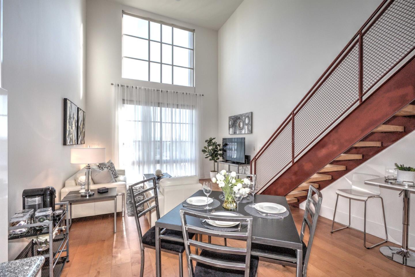 334 Santana Row, Unit 304 San Jose, CA 95128 - Photo 2 of 18 a living room with furniture a rug potted plant and a window