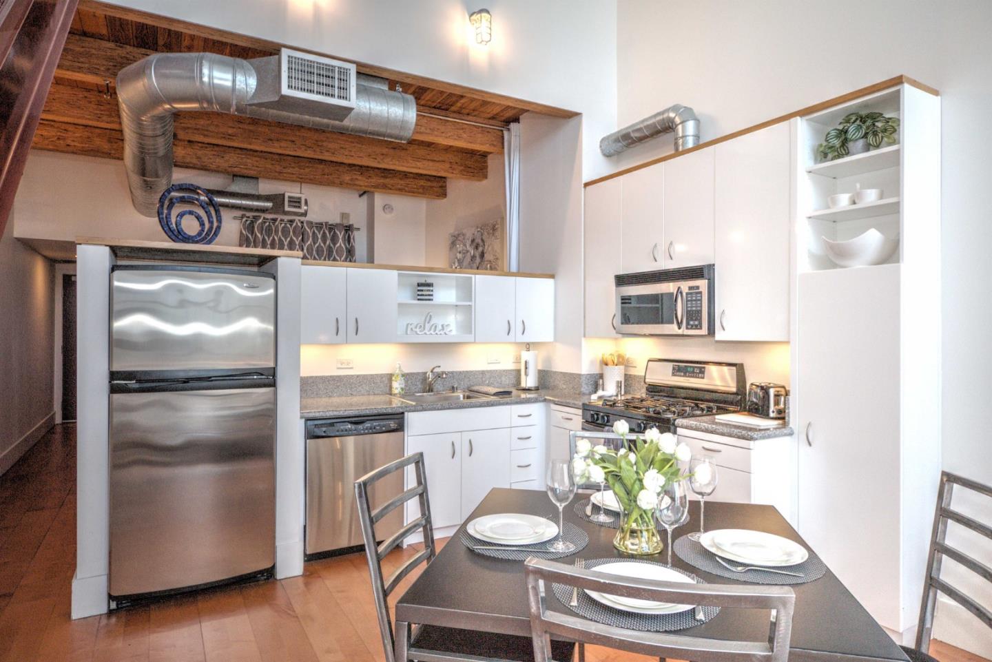 334 Santana Row, Unit 304 San Jose, CA 95128 - Photo 3 of 18 a kitchen with a refrigerator and a stove