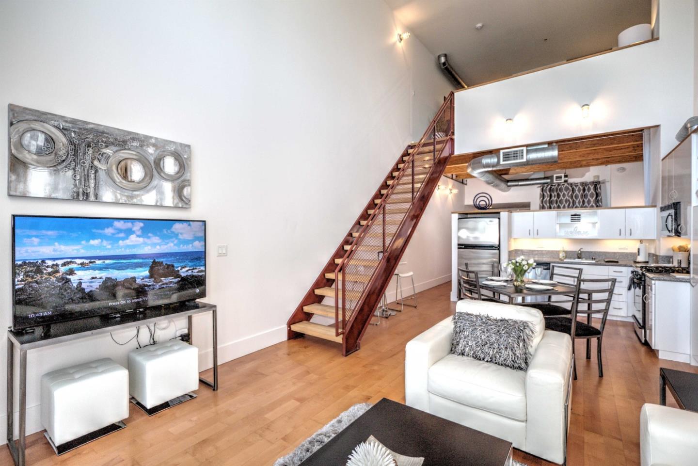 334 Santana Row, Unit 304 San Jose, CA 95128 - Photo 4 of 18 a living room with furniture and wooden floor