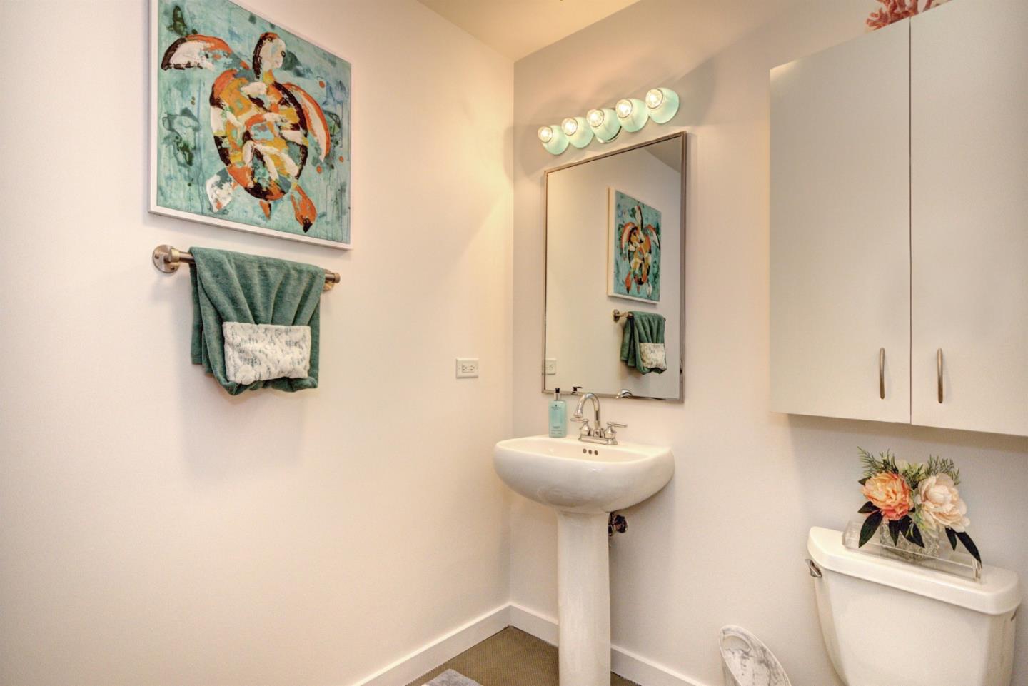 334 Santana Row, Unit 304 San Jose, CA 95128 - Photo 8 of 18 a bathroom with a sink and a mirror