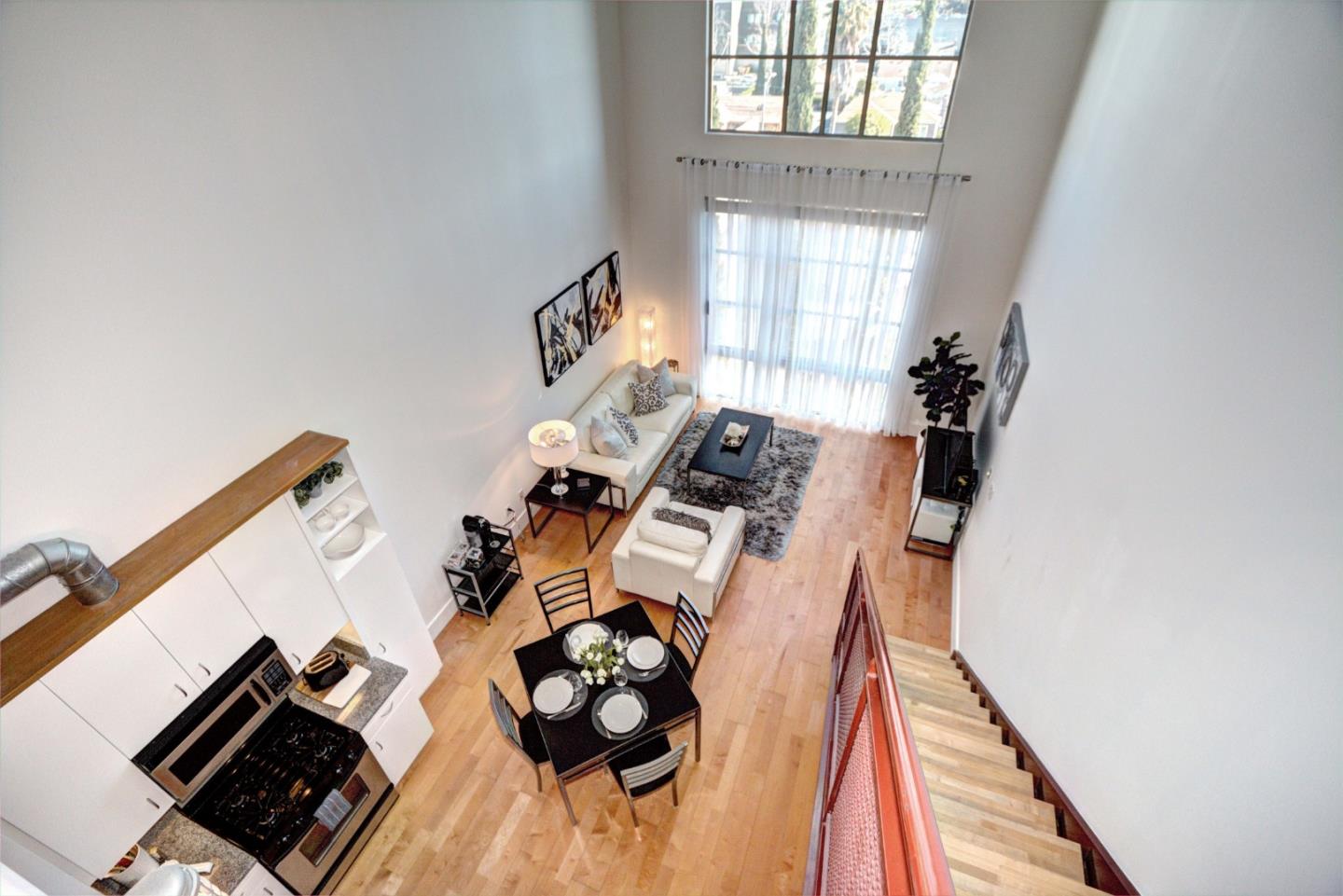 334 Santana Row, Unit 304 San Jose, CA 95128 - Photo 9 of 18 wooden floor with white walls and a stove