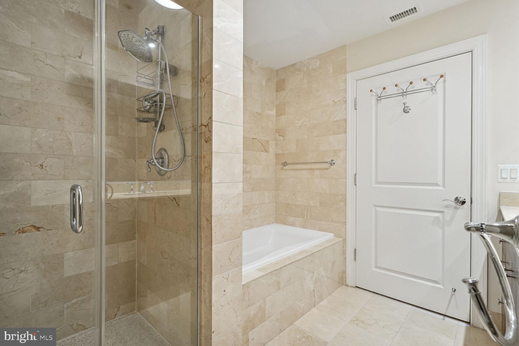 2425 L Street Northwest, Unit 637 Washington, DC 20037 - Photo 13 of 24 a bathroom with a bathtub and shower