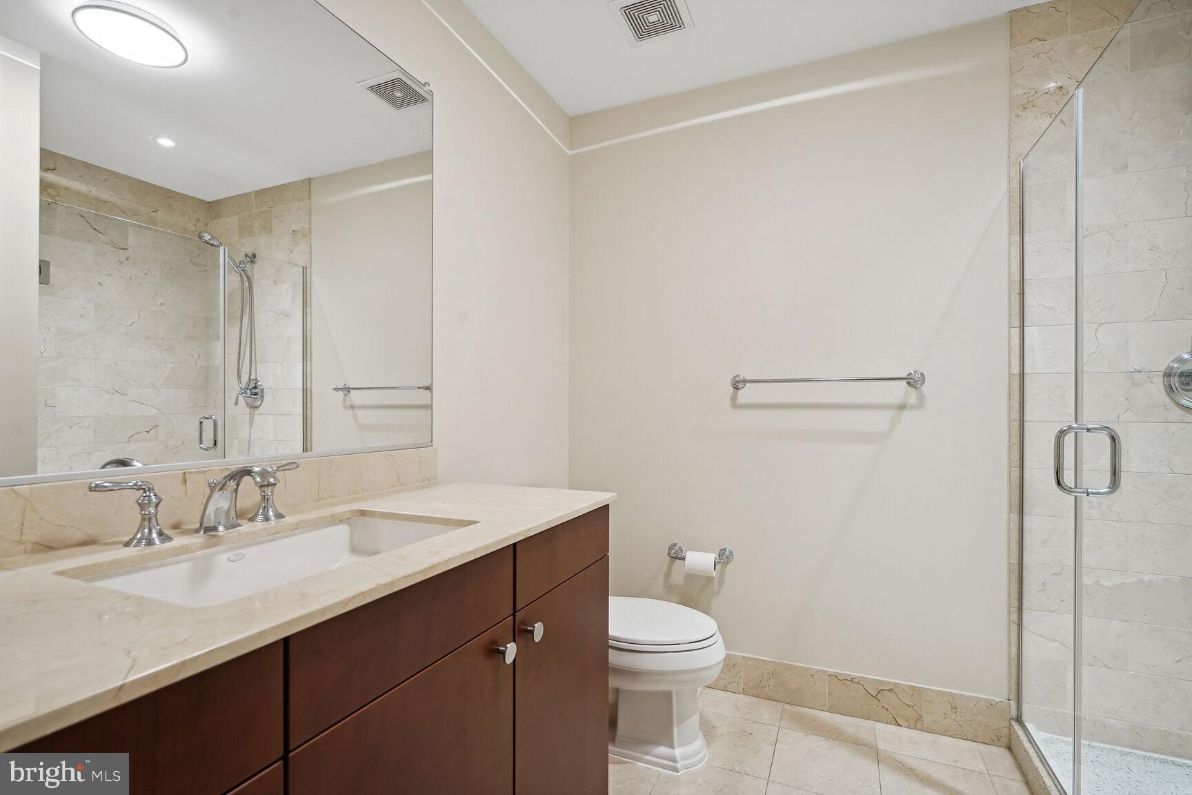2425 L Street Northwest, Unit 637 Washington, DC 20037 - Photo 17 of 24 a bathroom with a sink a toilet and shower