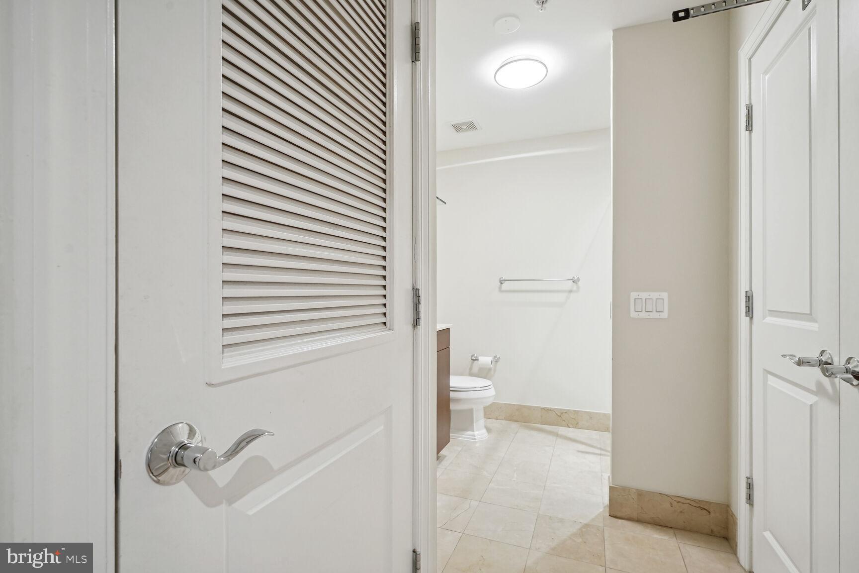 2425 L Street Northwest, Unit 637 Washington, DC 20037 - Photo 18 of 24 a bathroom with a granite countertop sink