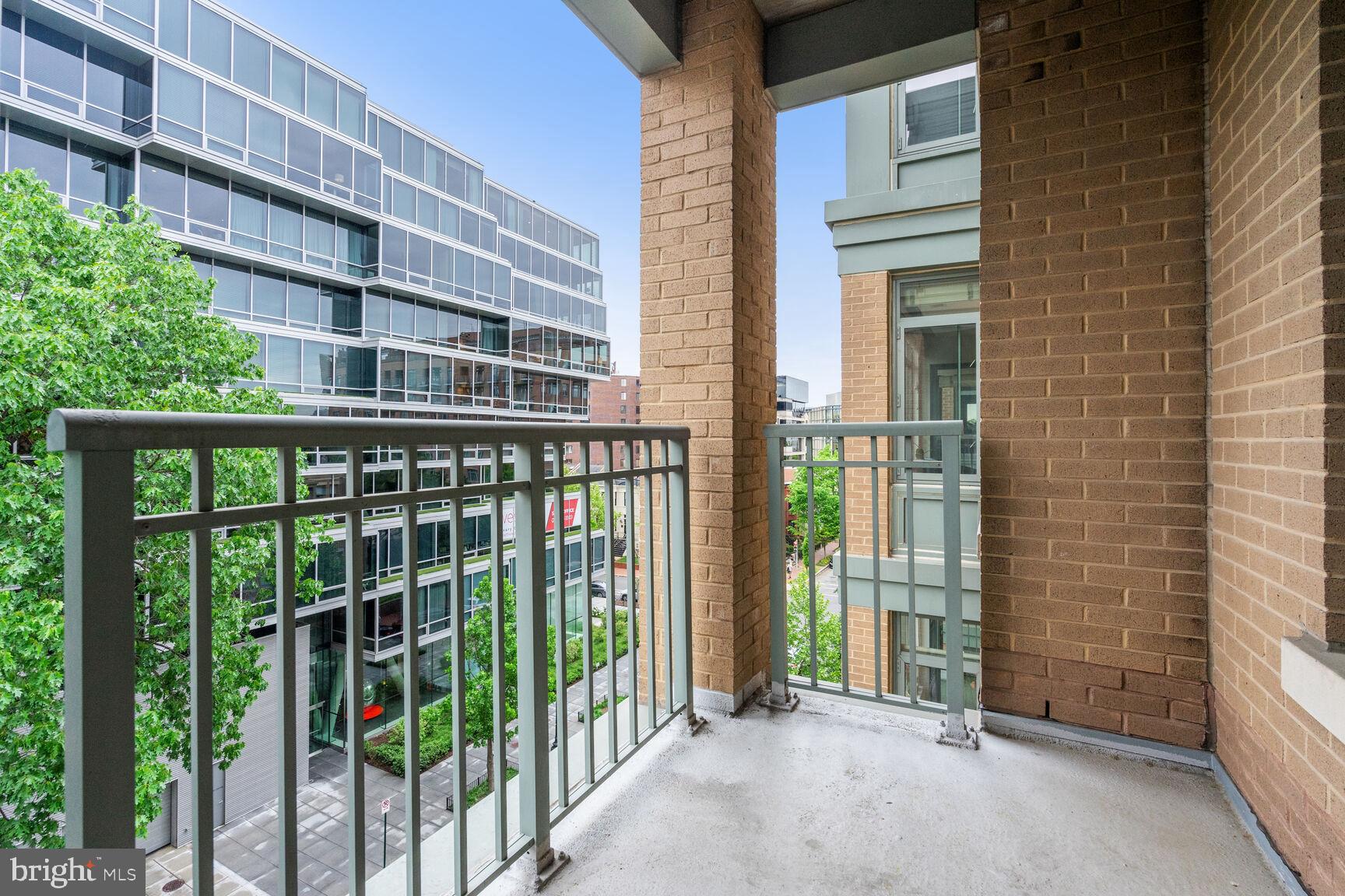 2425 L Street Northwest, Unit 637 Washington, DC 20037 - Photo 19 of 24 a view of a balcony with a floor to ceiling window and wooden fence