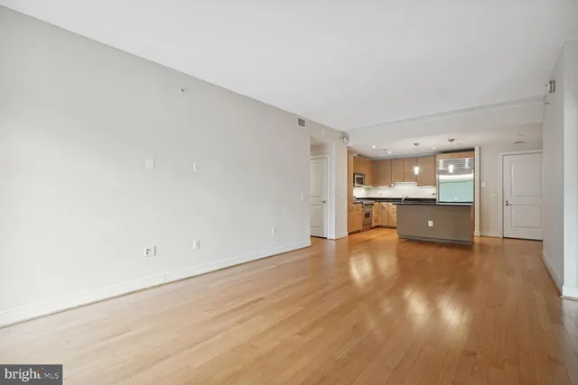 a view of a kitchen with wooden floor and a sink