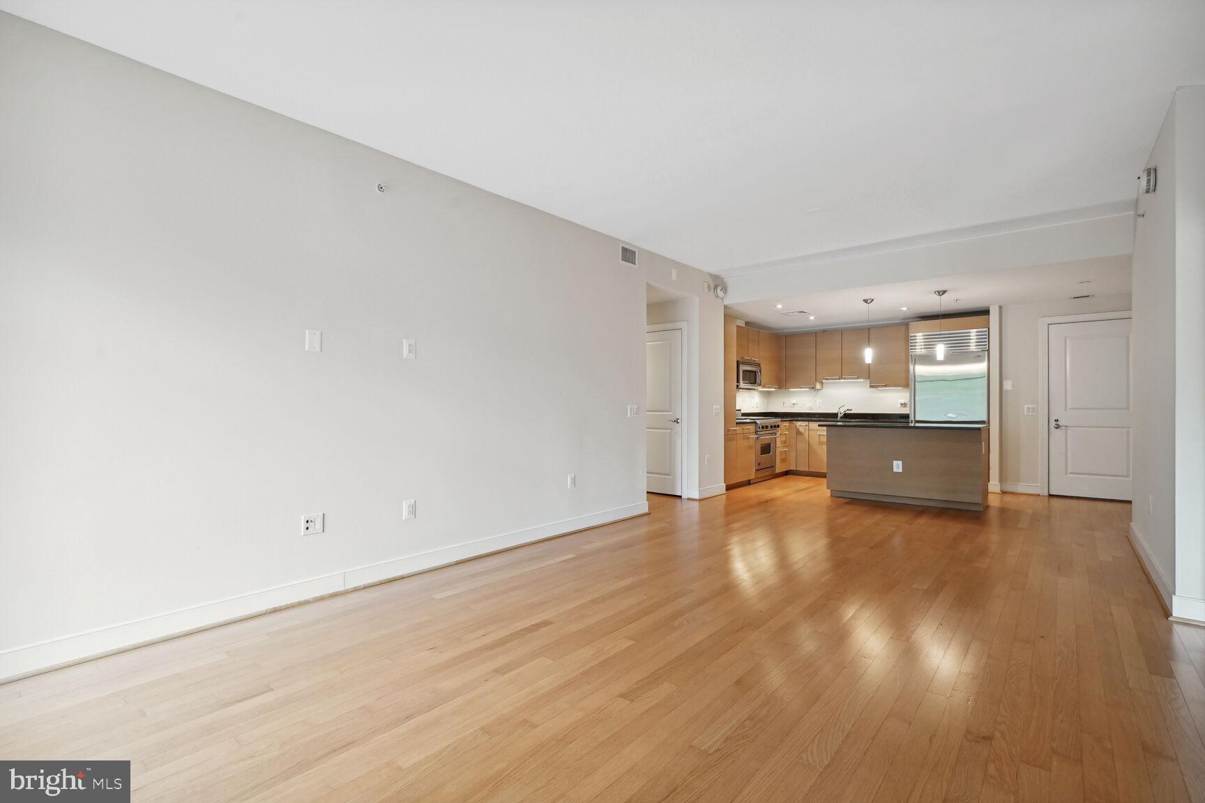 2425 L Street Northwest, Unit 637 Washington, DC 20037 - Photo 5 of 24 a view of a kitchen with wooden floor and a sink