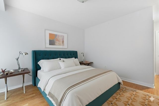 a bedroom with a bed and a chair