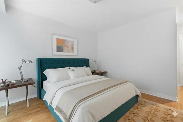 a bedroom with a bed and a chair