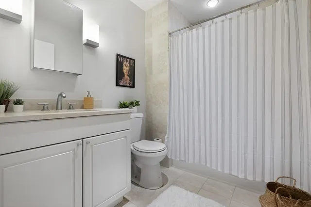 a bathroom with a sink a toilet and vanity