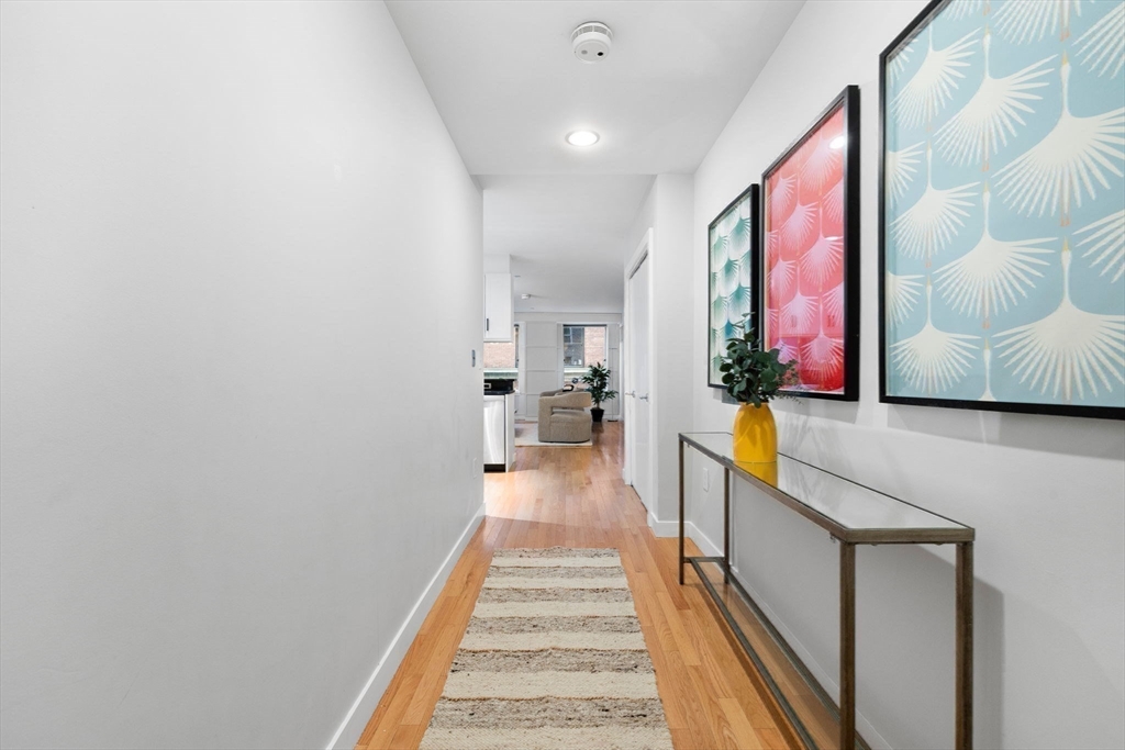 80 Broad Street, Unit 303 Boston, MA 02110 - Photo 19 of 23 a view of a hallway with a couch