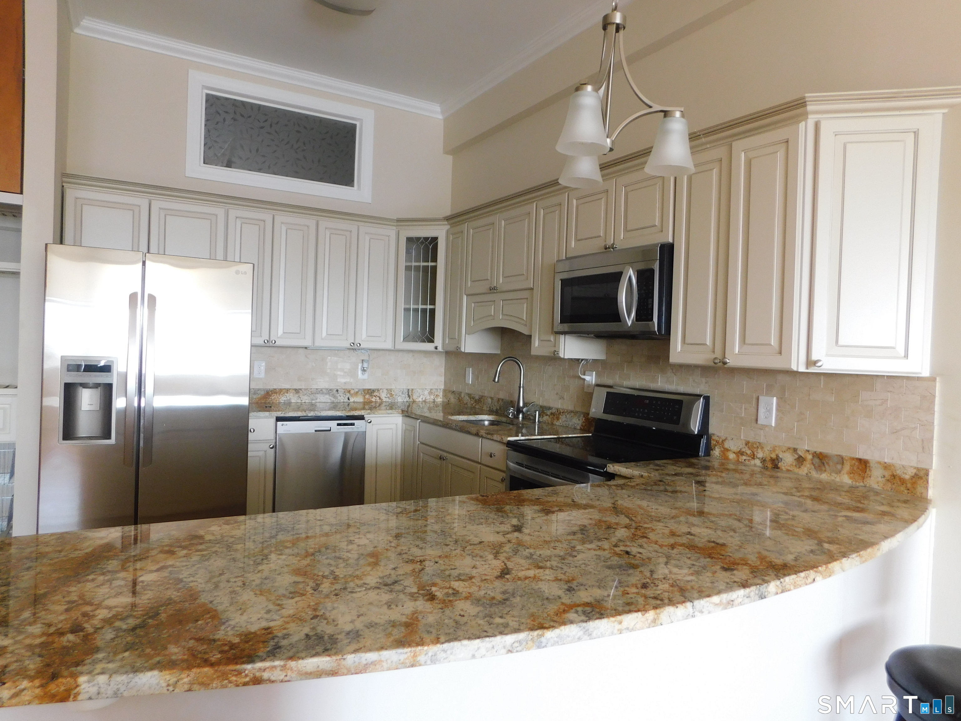 153 Bank Street, Unit 203 New London, CT 06320 - Photo 3 of 10 a kitchen with granite countertop a refrigerator a stove top oven a sink and dishwasher