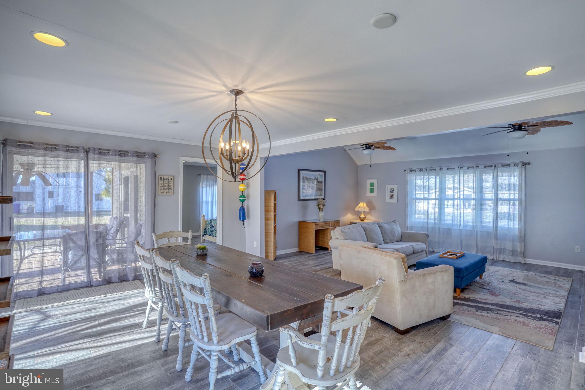 34772 Frontier Road Lewes, DE 19958 - Photo 17 of 66 a view of a dining room with furniture wooden floor and chandelier