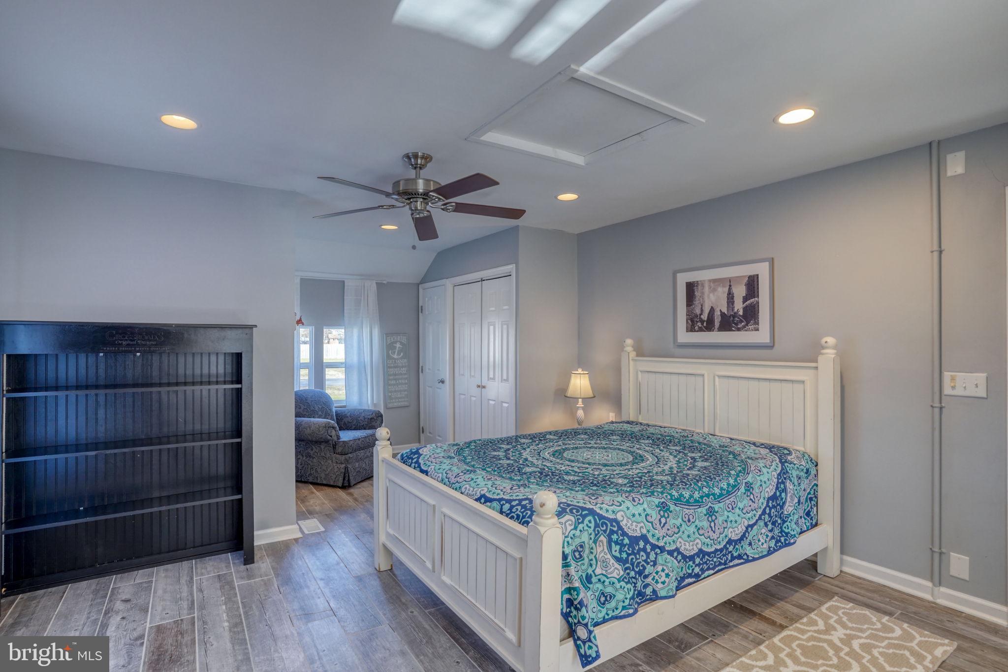 34772 Frontier Road Lewes, DE 19958 - Photo 21 of 66 a bedroom with a bed and a chandelier
