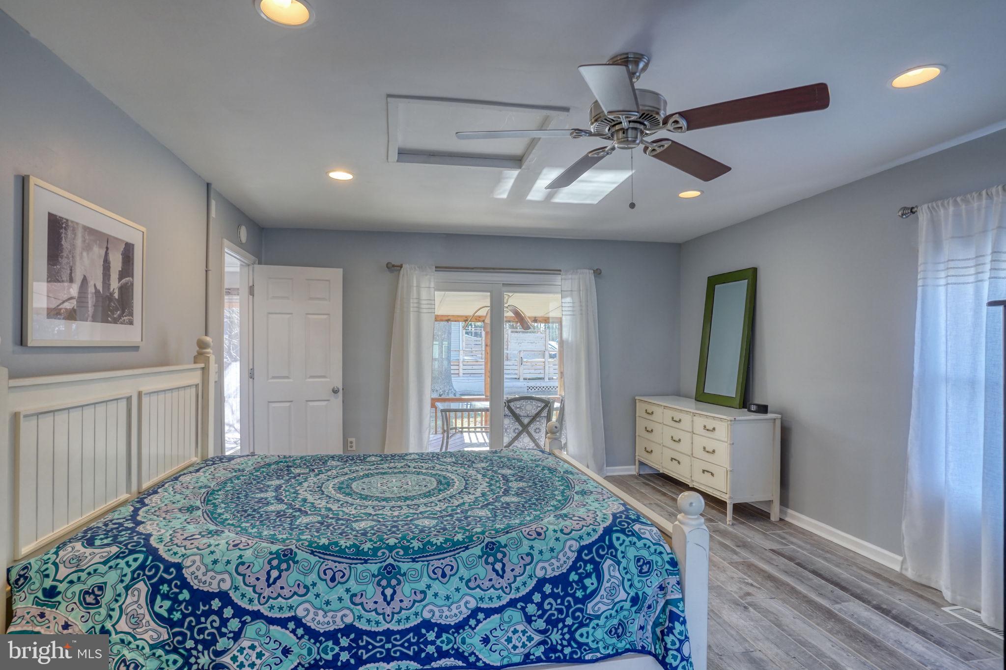 34772 Frontier Road Lewes, DE 19958 - Photo 22 of 66 a spacious bedroom with a bed and a dresser