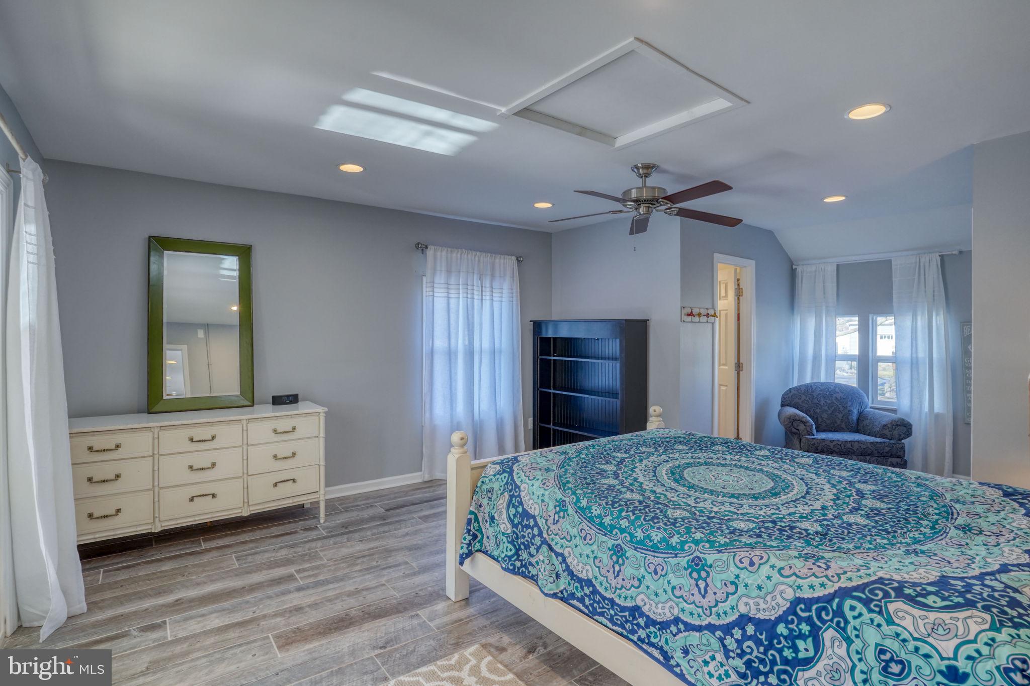 34772 Frontier Road Lewes, DE 19958 - Photo 23 of 66 a large bedroom with a bed and a dresser