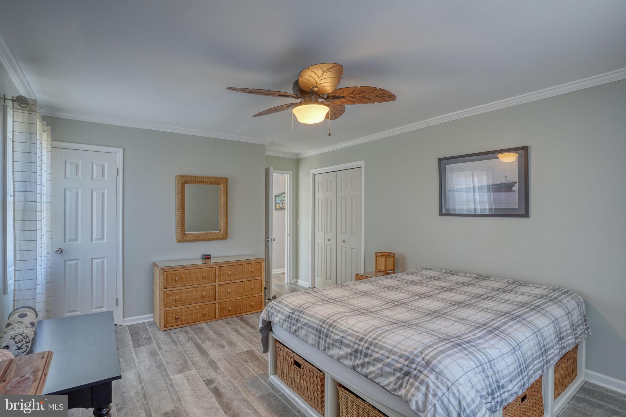 34772 Frontier Road Lewes, DE 19958 - Photo 25 of 66 a bedroom with a bed and a chandelier