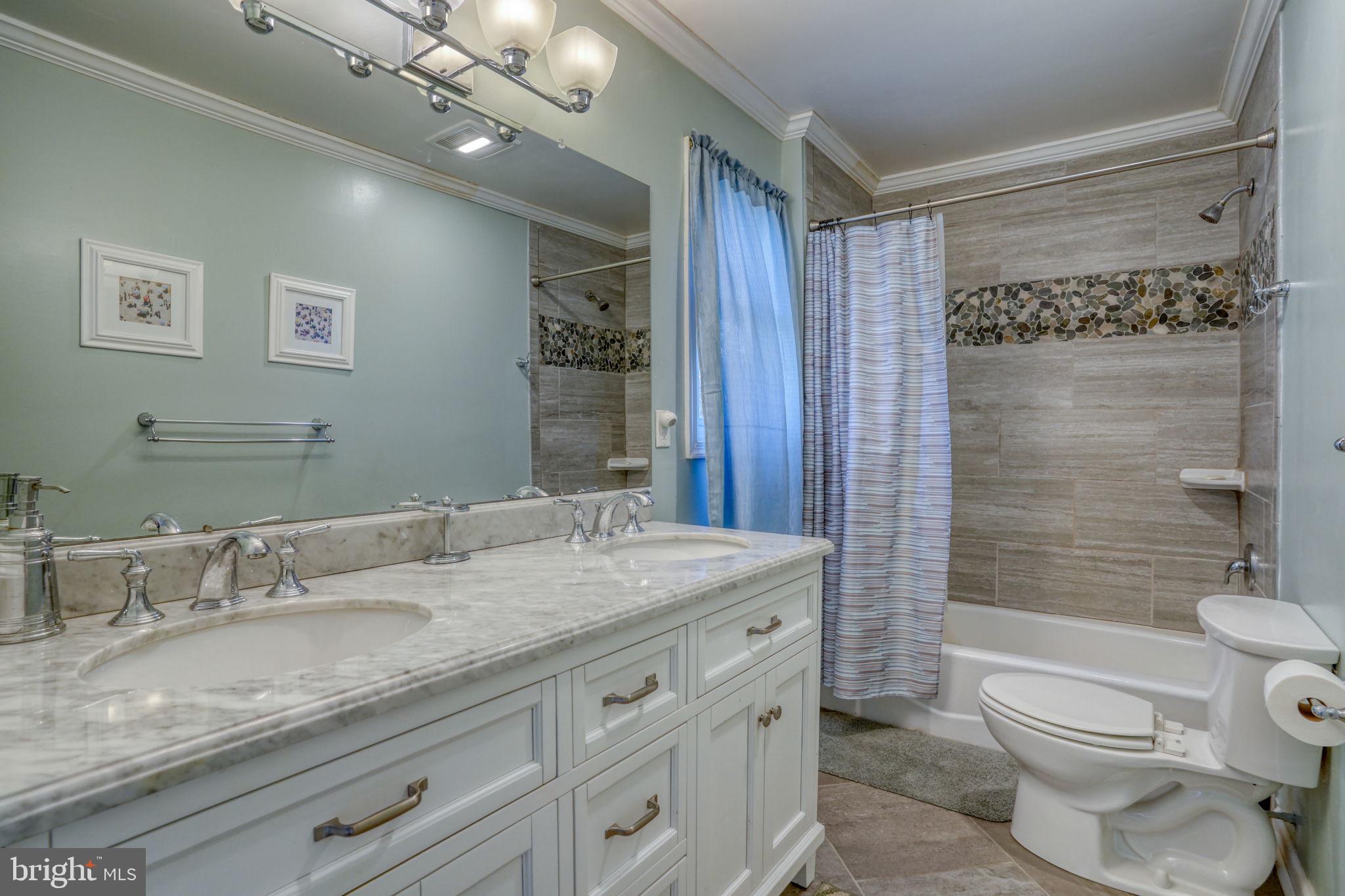 34772 Frontier Road Lewes, DE 19958 - Photo 28 of 66 a bathroom with a granite countertop sink toilet mirror and shower