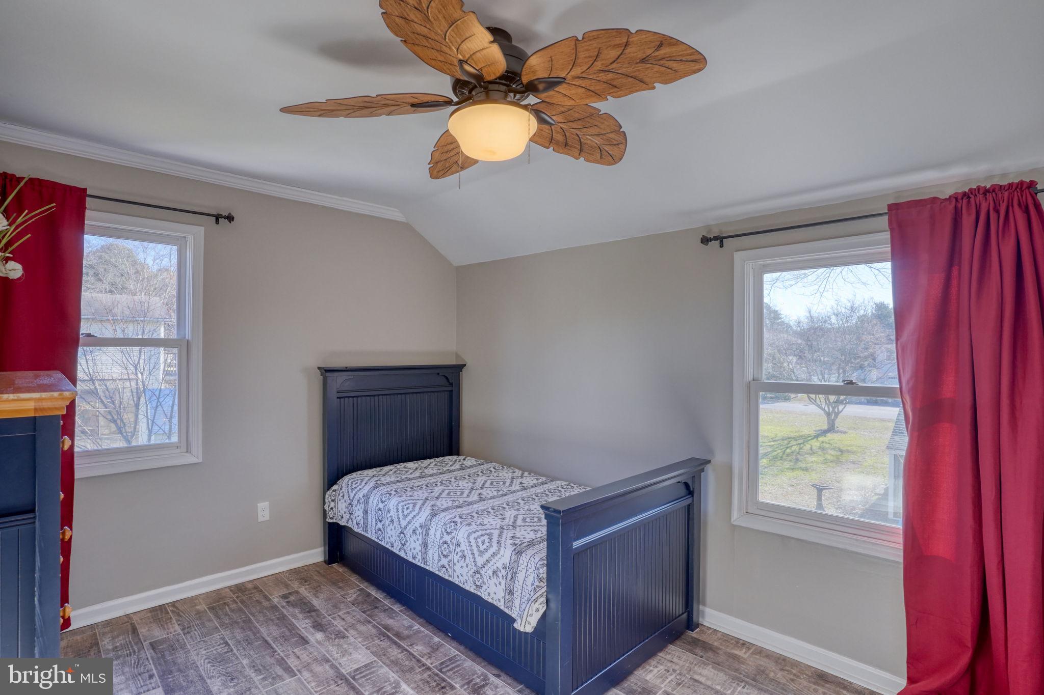 34772 Frontier Road Lewes, DE 19958 - Photo 31 of 66 a bedroom with a large bed and a window