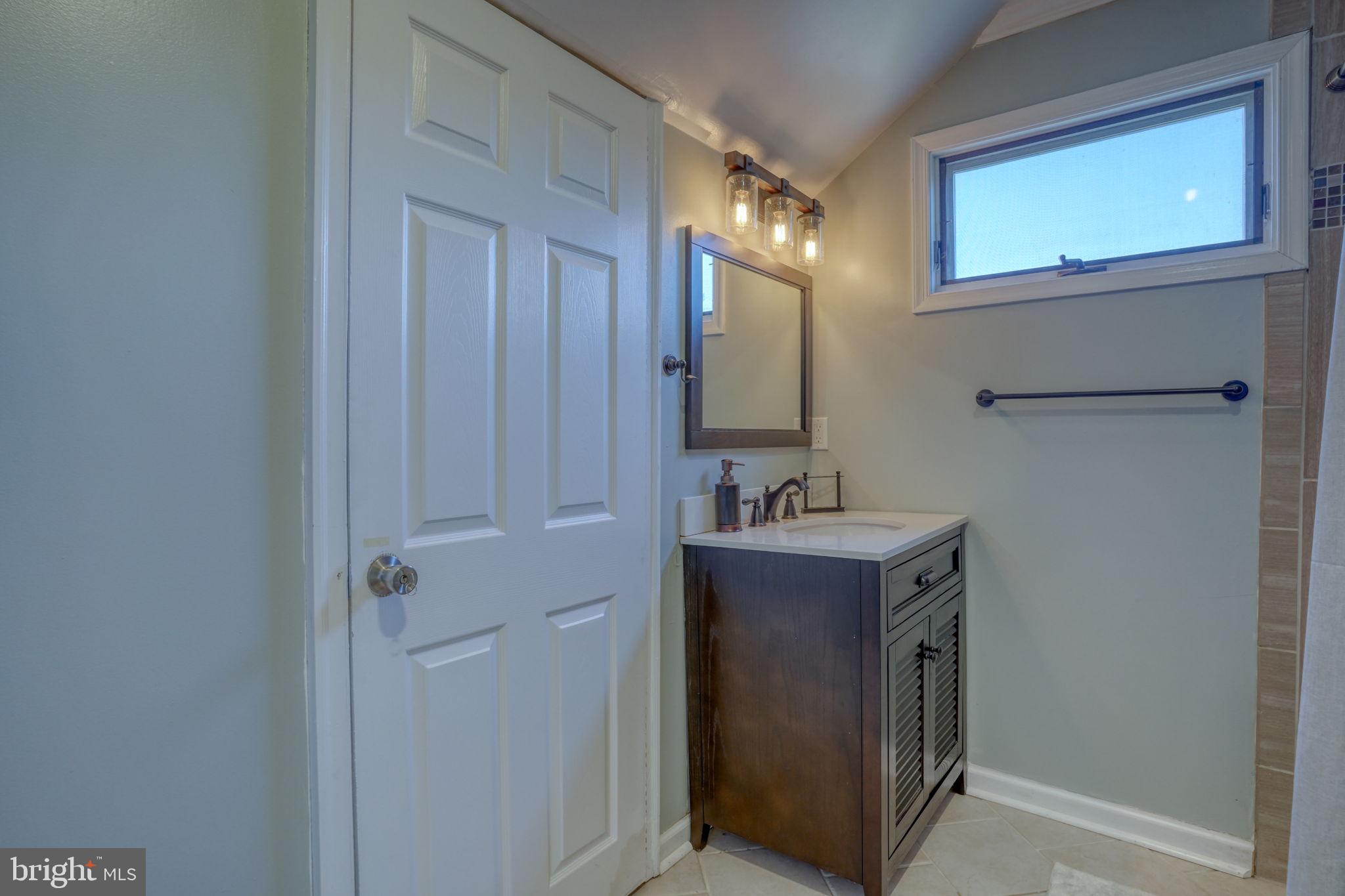 34772 Frontier Road Lewes, DE 19958 - Photo 35 of 66 a view of a bathroom with a sink and mirror