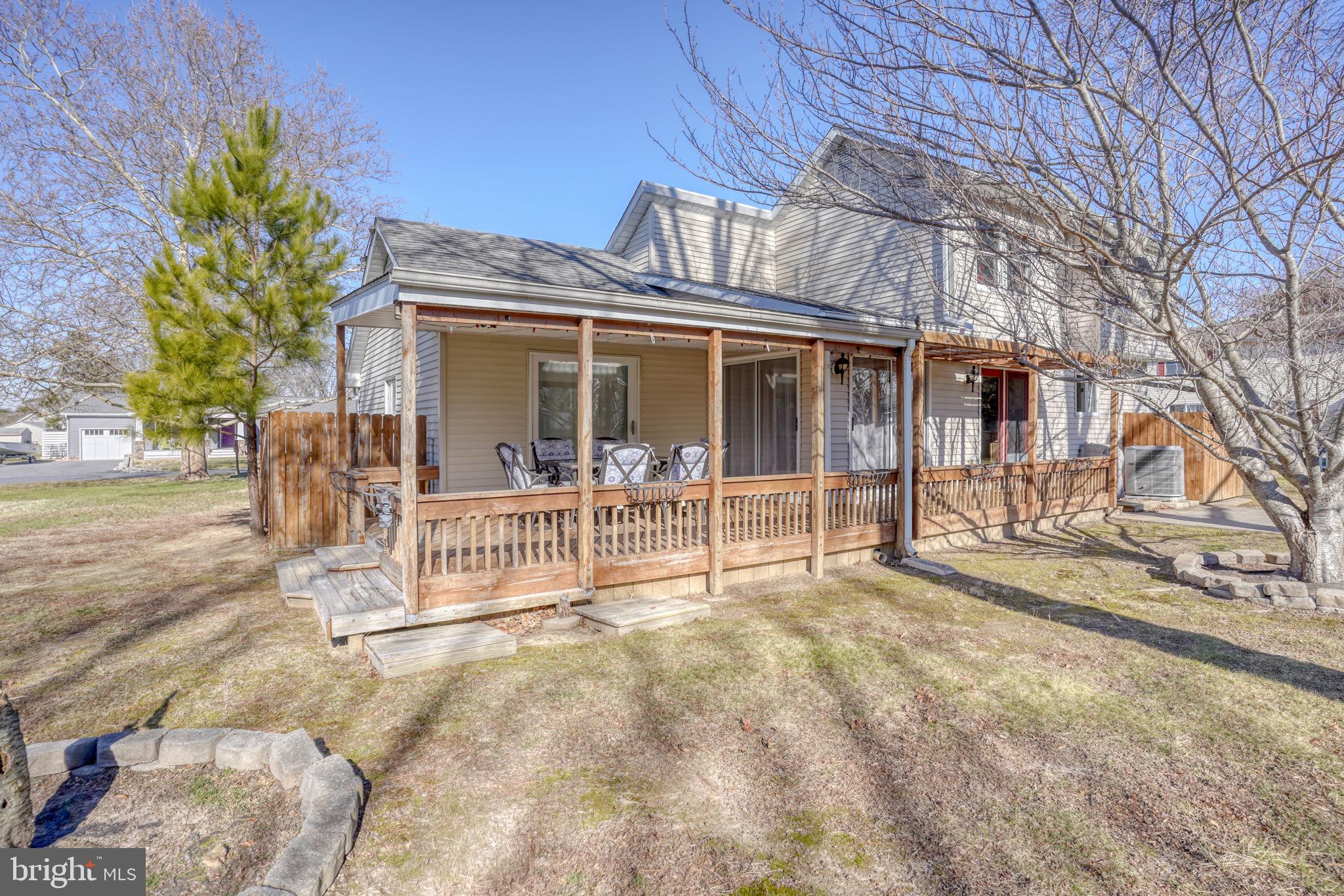 34772 Frontier Road Lewes, DE 19958 - Photo 39 of 66 a view of a house with a large window and wooden fence
