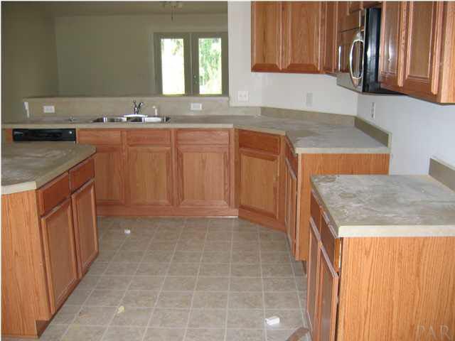 2159 Liberty Loop Road, Unit 10C Cantonment, FL 32533 - Photo 2 of 6 KITCHEN WITH ISLAND AND WALK IN PANTRY