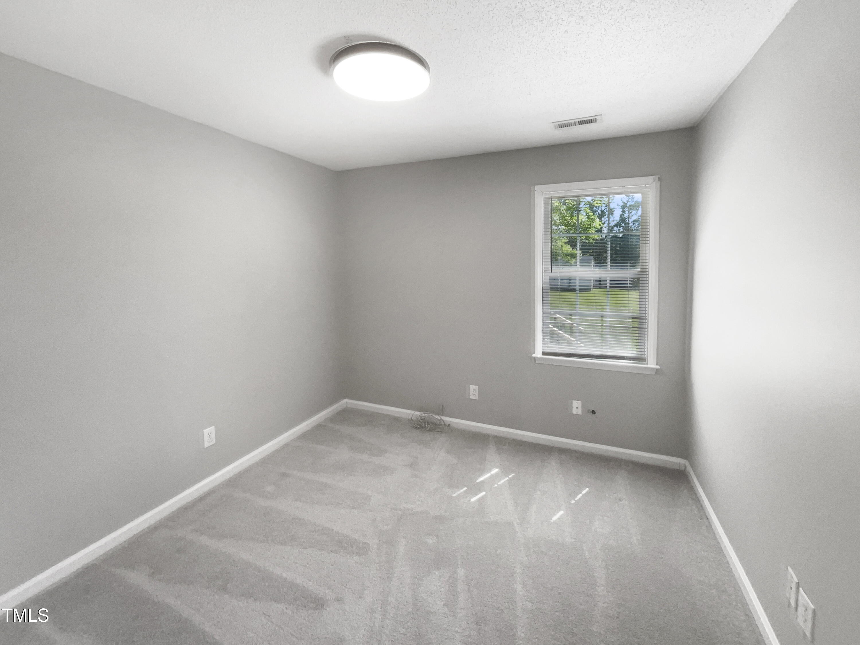 1661 Lee Road Clayton, NC 27520 - Photo 11 of 15 an empty room with a window