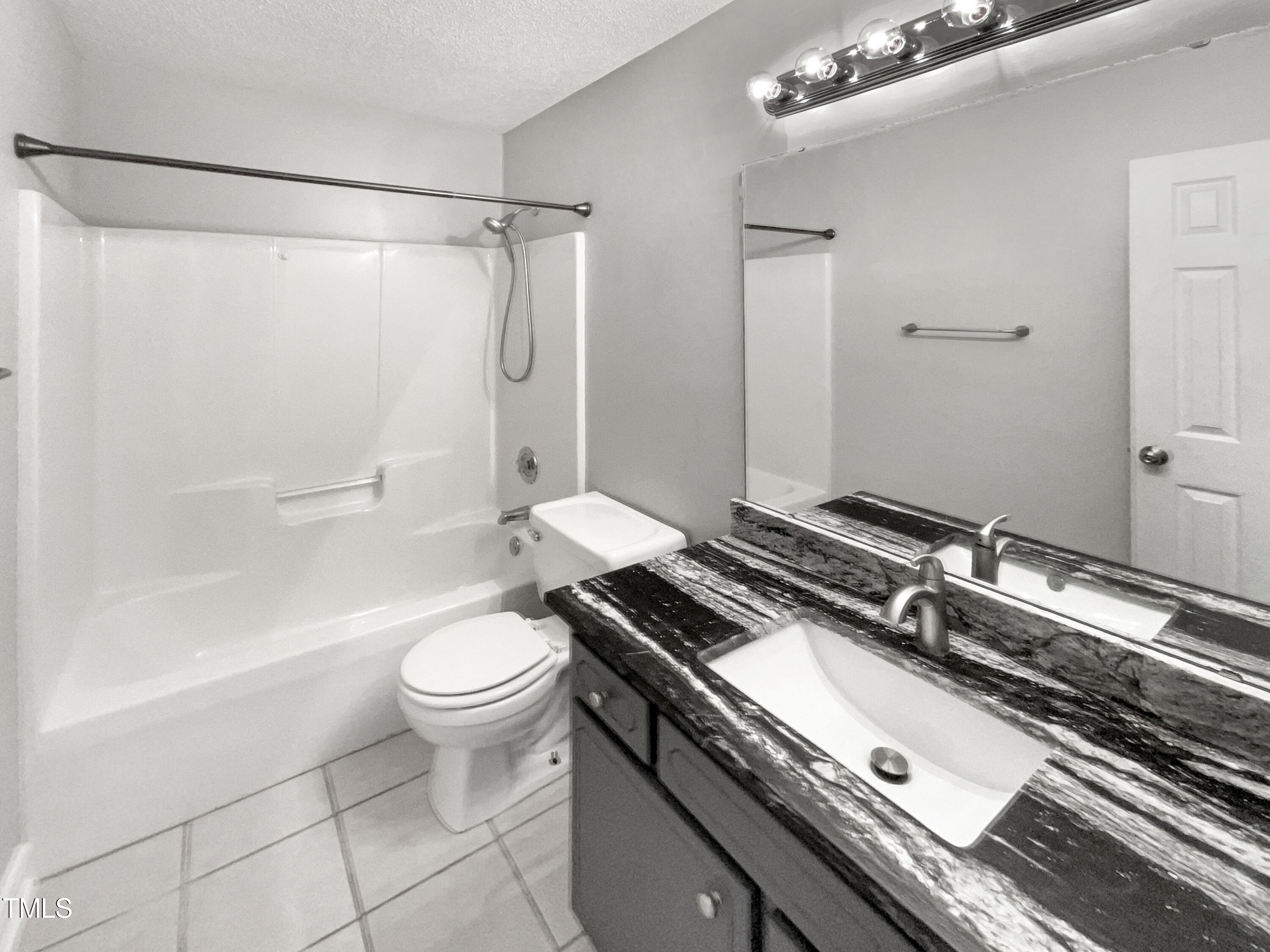 1661 Lee Road Clayton, NC 27520 - Photo 12 of 15 a bathroom with a granite countertop sink toilet and shower