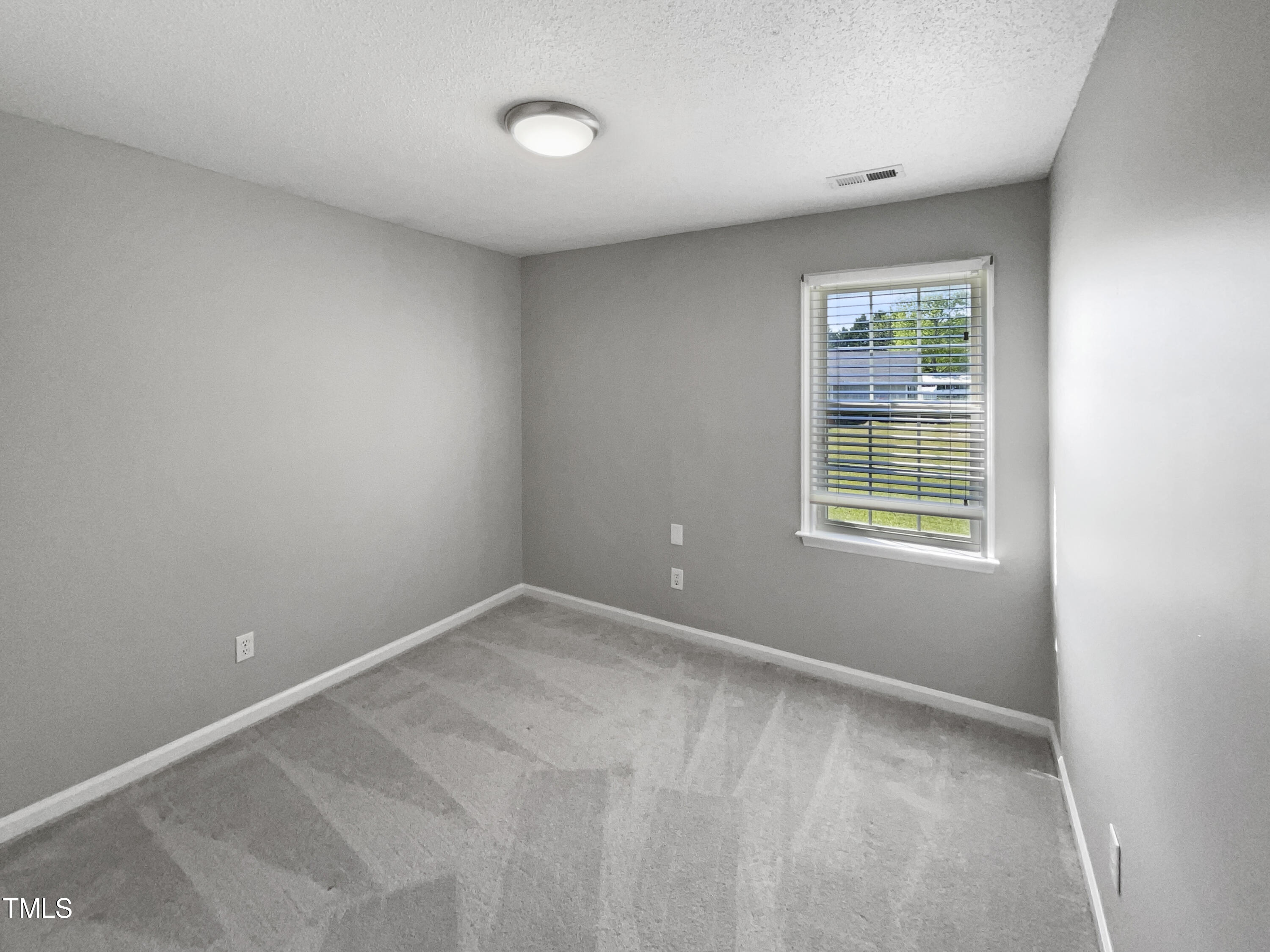 1661 Lee Road Clayton, NC 27520 - Photo 13 of 15 an empty room with a window