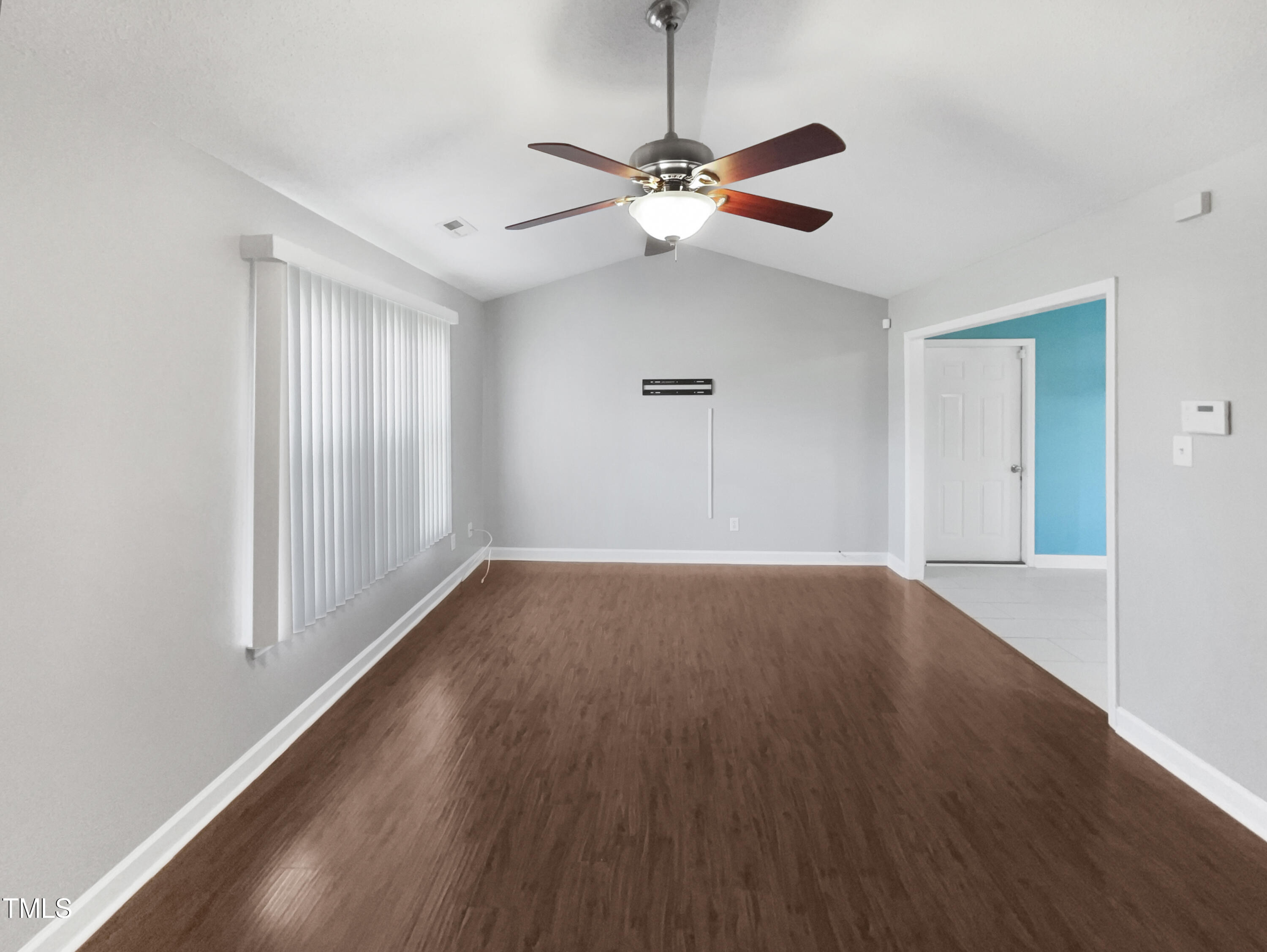 1661 Lee Road Clayton, NC 27520 - Photo 2 of 15 a view of room with window ceiling fan and hardwood floor