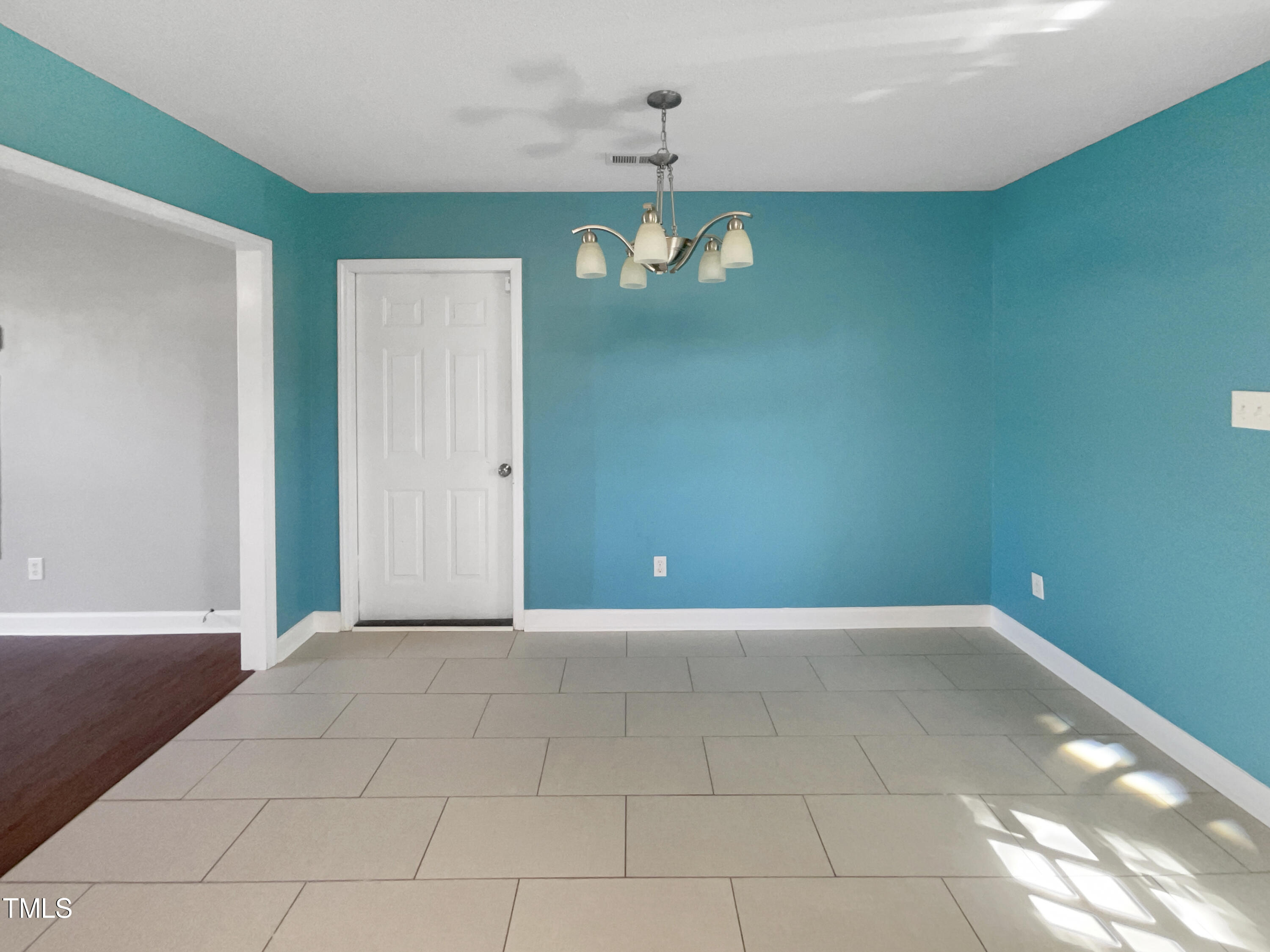 1661 Lee Road Clayton, NC 27520 - Photo 5 of 15 a view of an empty room with window and chandelier fan