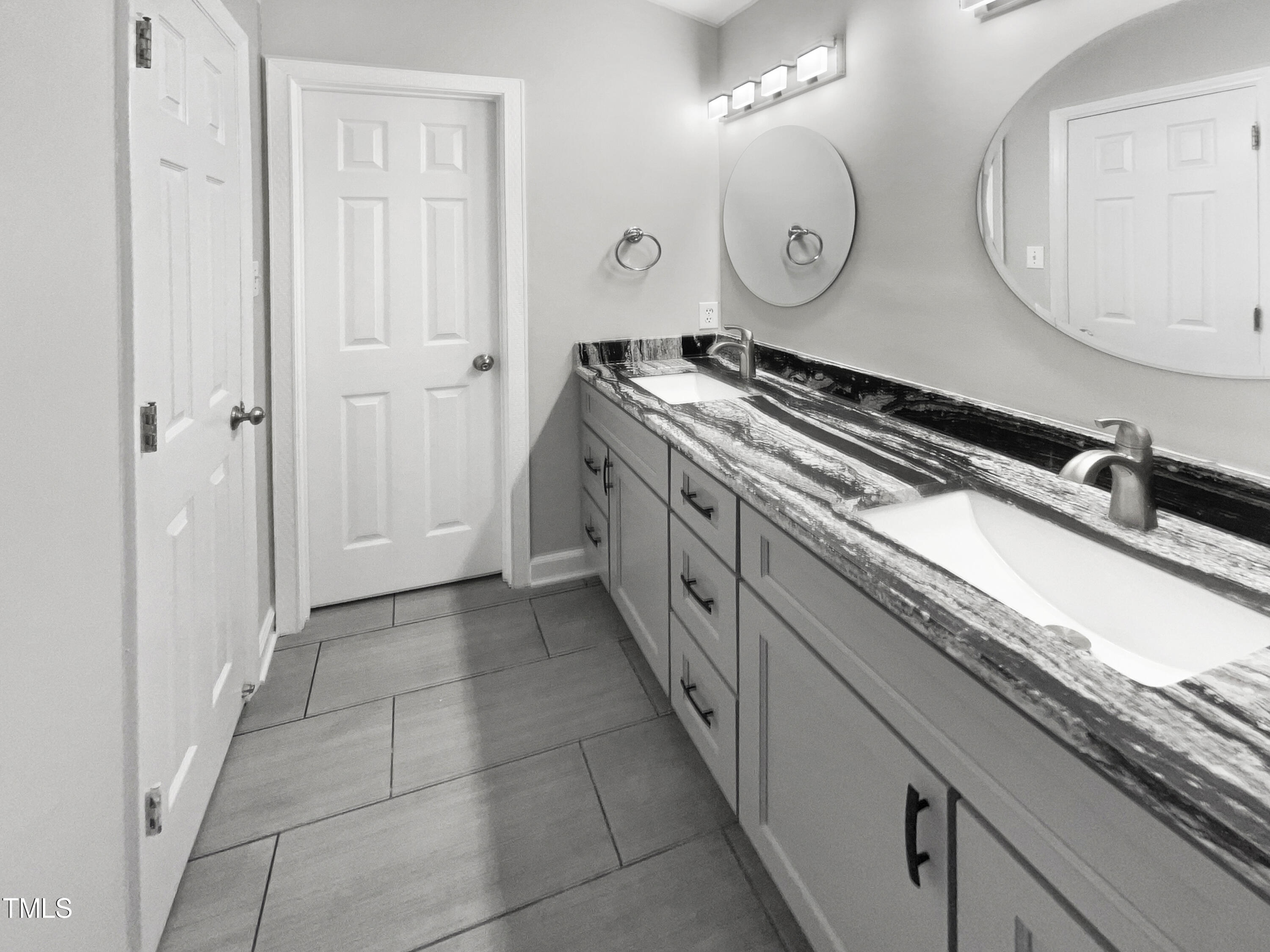 1661 Lee Road Clayton, NC 27520 - Photo 9 of 15 a spacious bathroom with a granite countertop sink a mirror and a toilet