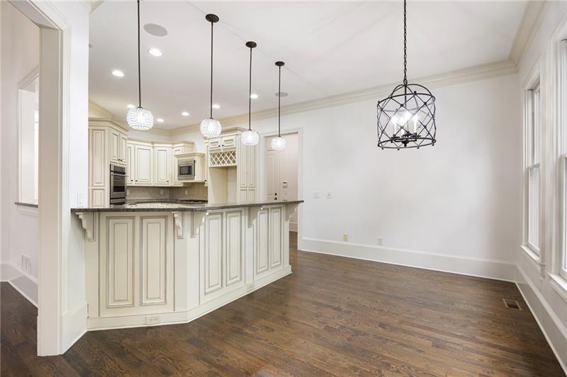 6186 Talmadge Run Acworth, GA 30101 - Photo 12 of 54 a view of a kitchen with stainless steel appliances granite countertop cabinets and wooden floor