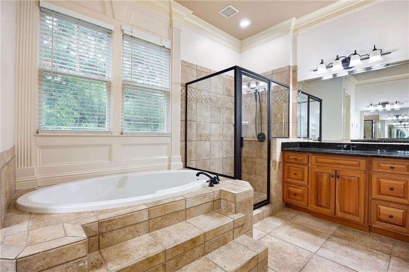 6186 Talmadge Run Acworth, GA 30101 - Photo 24 of 54 a spacious bathroom with a tub sink and mirror
