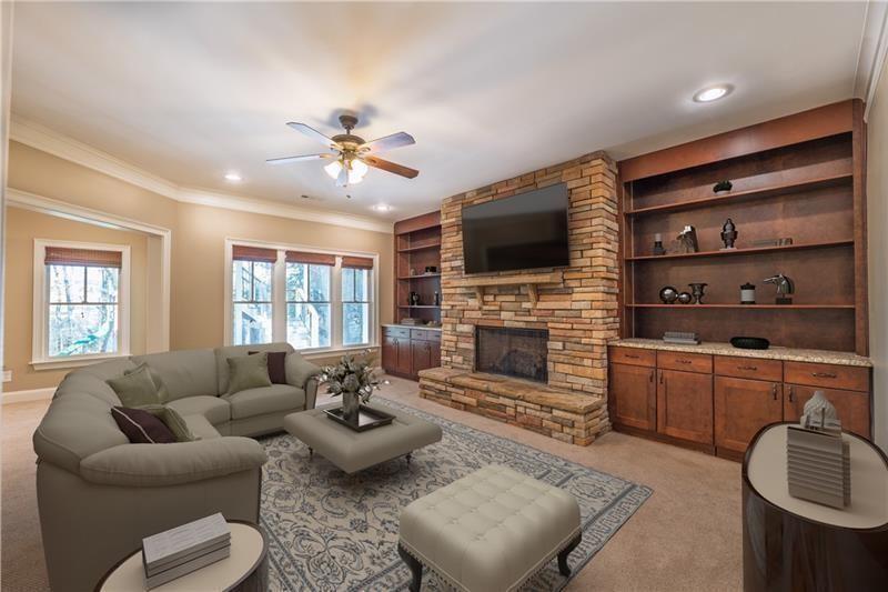 6186 Talmadge Run Acworth, GA 30101 - Photo 28 of 54 a living room with furniture a fireplace and a flat screen tv