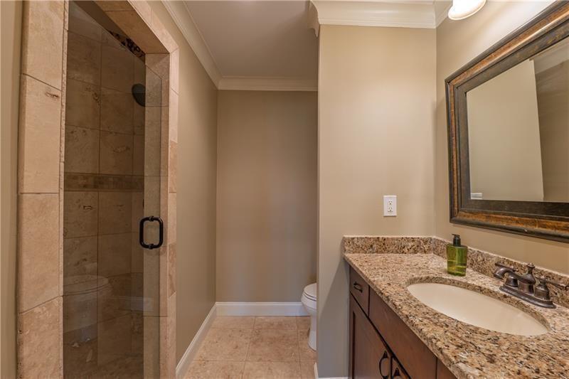 6186 Talmadge Run Acworth, GA 30101 - Photo 32 of 54 a bathroom with a granite countertop sink and a mirror