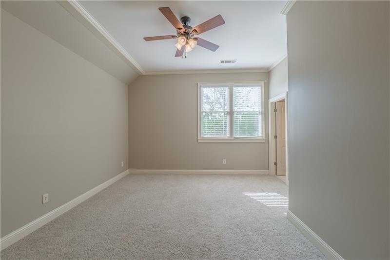 6186 Talmadge Run Acworth, GA 30101 - Photo 34 of 54 an empty room with a window and a ceiling fan