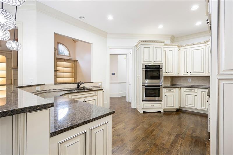 6186 Talmadge Run Acworth, GA 30101 - Photo 10 of 54 a kitchen with stainless steel appliances granite countertop a stove a sink and a refrigerator