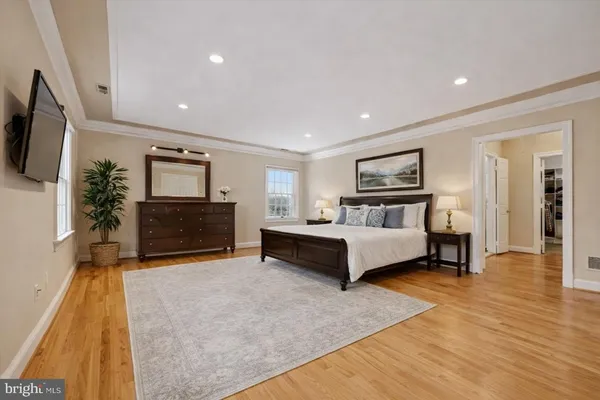 a bedroom with bed and wooden floor